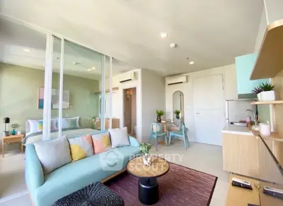 Modern open-plan living room with stylish decor and compact kitchen area