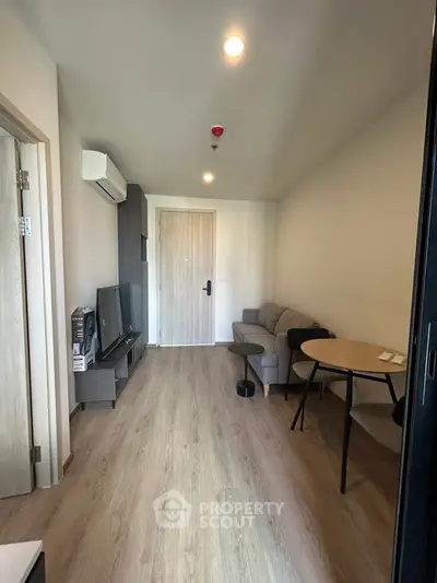 Modern living room with sleek furniture and wooden flooring