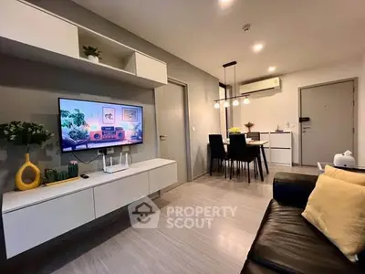 Modern living room with sleek furniture and open dining area, featuring stylish decor and ambient lighting.