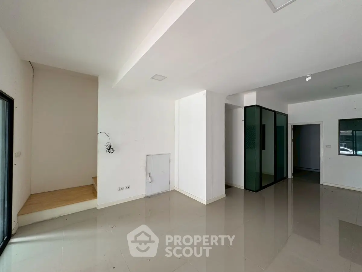 Spacious modern interior with sleek glass partitions and glossy tiled flooring