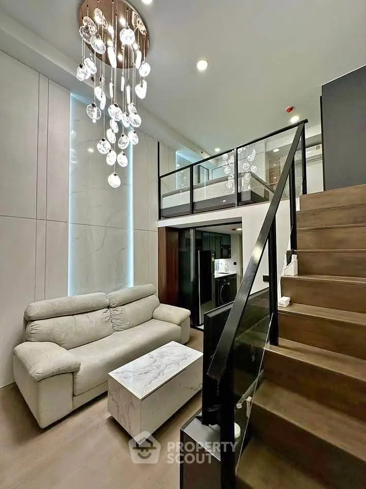 Modern loft apartment with elegant chandelier and stylish staircase