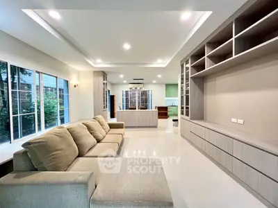Spacious modern living room with large windows and built-in shelving