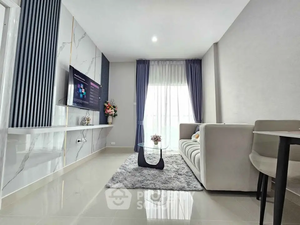 Modern living room with sleek design, marble accents, and cozy seating area.