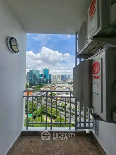 Stunning city view from a high-rise balcony with air conditioning units.