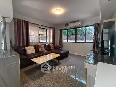 Spacious living room with modern decor and large windows for natural light.