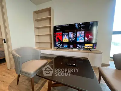 Modern living room with stylish furniture and wall-mounted TV, perfect for entertainment and relaxation.