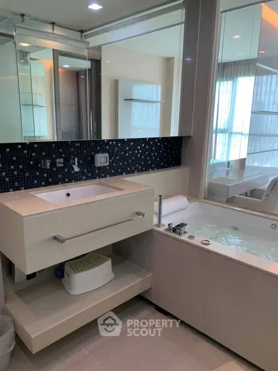 Luxurious bathroom with modern fixtures and a relaxing bathtub in a stylish apartment.