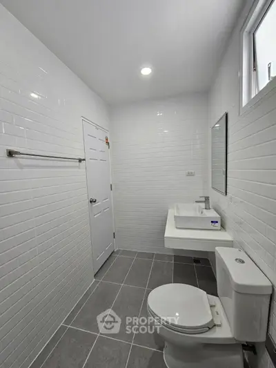 Modern bathroom with sleek white tiles and contemporary fixtures