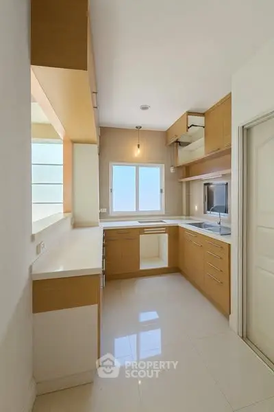 Modern kitchen with sleek cabinetry and ample natural light
