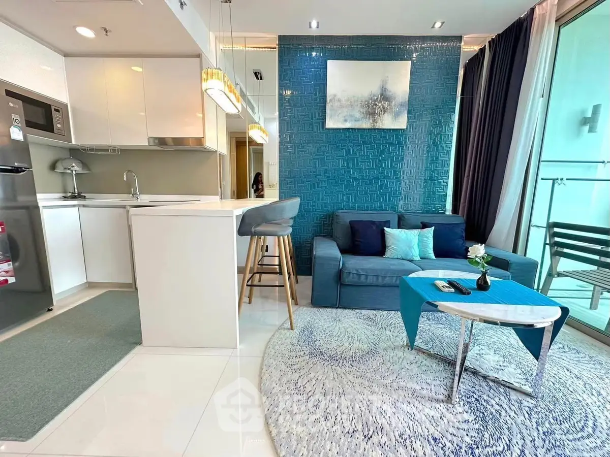 Modern open-plan living room with stylish kitchen and balcony access