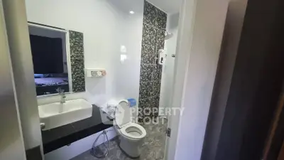 Modern bathroom with stylish tiles and sleek fixtures in a contemporary home.