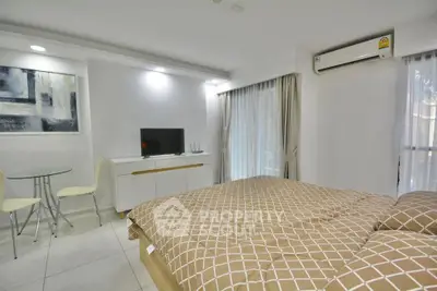Modern bedroom with stylish decor and natural light in a cozy apartment