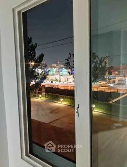 Stunning night view from a modern apartment window overlooking city lights and urban landscape.