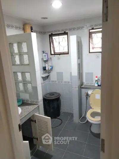 Cozy bathroom with modern fixtures and ample storage space.