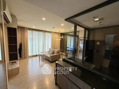Spacious modern living room with elegant decor and large windows for natural light.