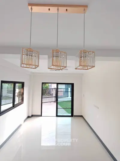 Spacious modern living room with elegant lighting and garden view.