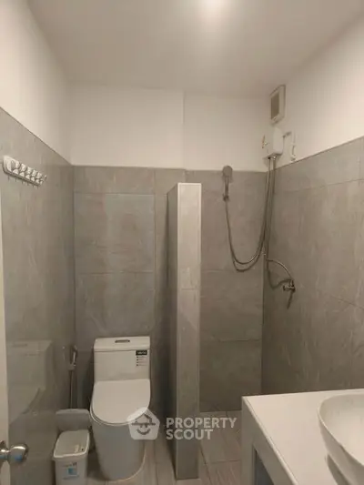 Modern bathroom with sleek gray tiles and contemporary fixtures