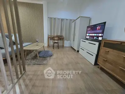 Modern living room with stylish furniture and TV, perfect for relaxation and entertainment.