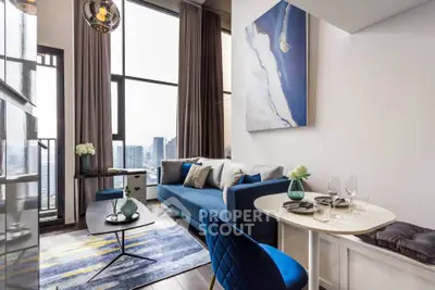 Modern living room with city view, stylish blue sofa, and elegant decor