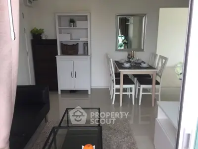 Modern living room with dining area, stylish furniture, and elegant decor in a cozy apartment.