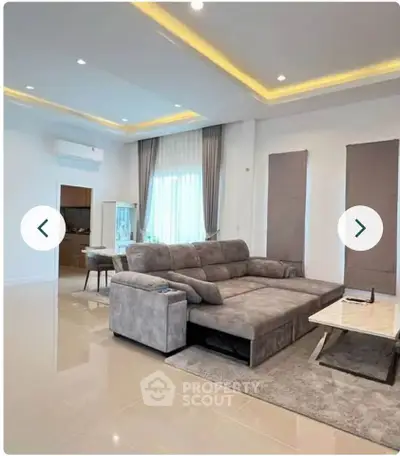Spacious modern living room with elegant sofa and stylish decor