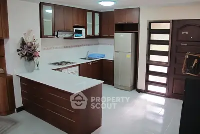 Modern kitchen with wooden cabinets and sleek countertops in a cozy home