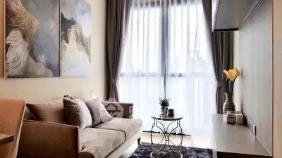 Elegant living room with modern decor and large window for natural light.