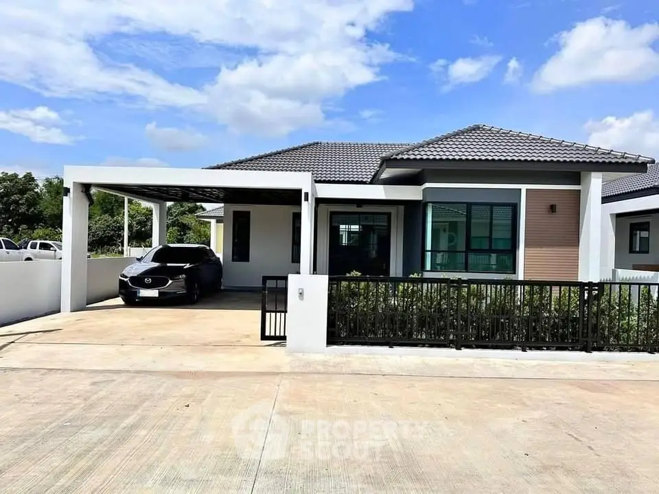 Modern single-story house with carport and sleek design under a clear blue sky.