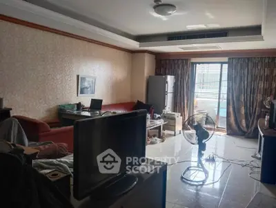 Spacious living room with modern furniture and balcony access, ideal for comfortable urban living.