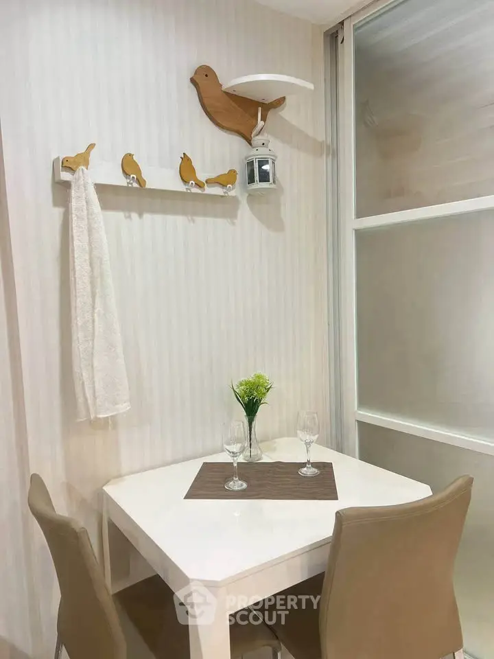 Charming dining nook with modern decor and bird-themed accents, perfect for cozy meals.