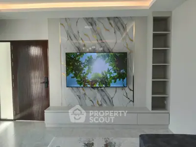 Modern living room with marble accent wall and built-in shelving