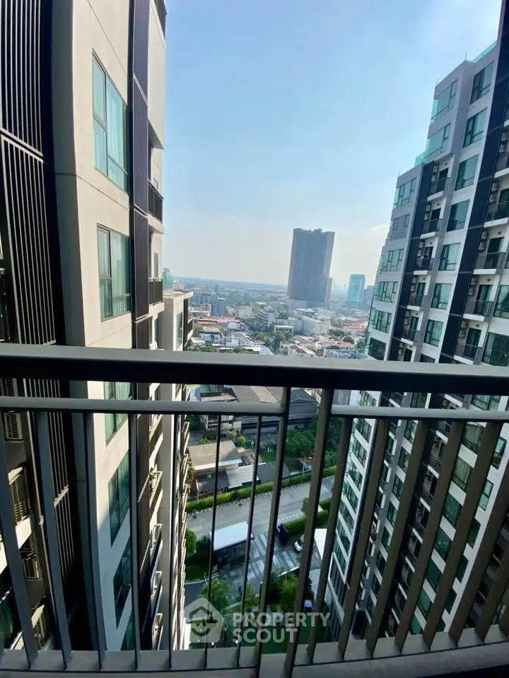 Stunning cityscape view from high-rise balcony with modern architecture.