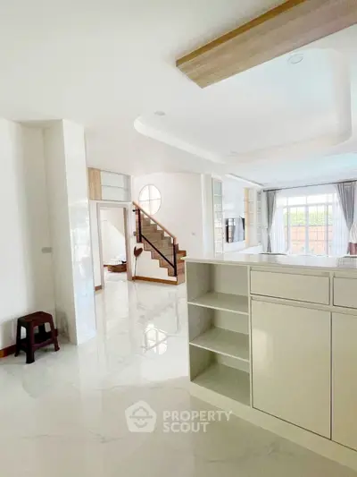 Spacious open-plan living area with modern design and natural light