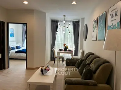 Charming living room with elegant decor and cozy bedroom view, perfect for modern living.