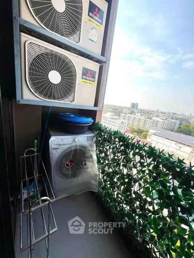 Compact balcony with air conditioning units and city view
