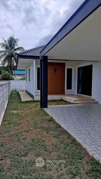 Charming single-story home with spacious patio and lush garden, perfect for outdoor living.