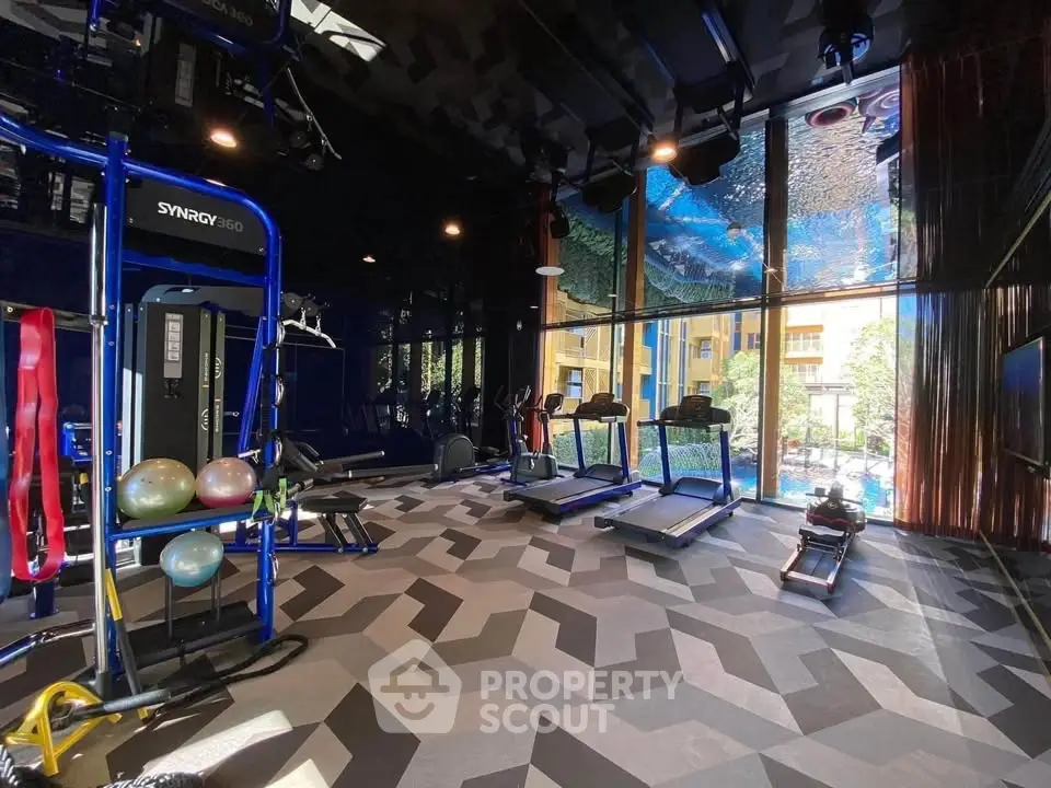 Luxurious gym with modern equipment and stunning city view, perfect for fitness enthusiasts seeking premium amenities.