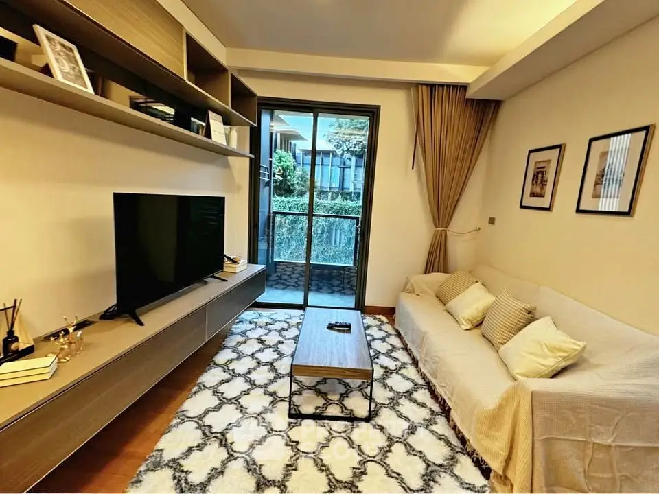 Cozy living room with modern decor and garden view, perfect for relaxation.