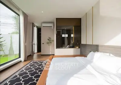 Luxurious modern bedroom with large windows and elegant decor