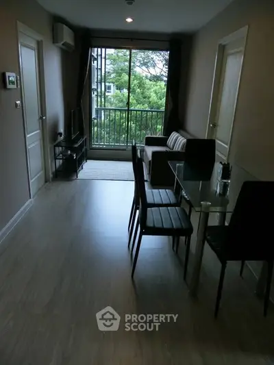 Modern living room with glass dining table and large window view