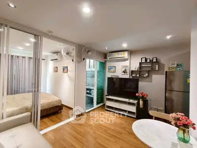 Modern apartment interior with open living room, bedroom, and kitchen featuring sleek design and cozy ambiance.
