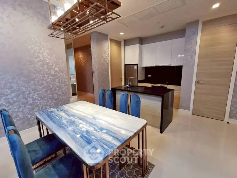 Modern kitchen with elegant dining area and stylish blue chairs