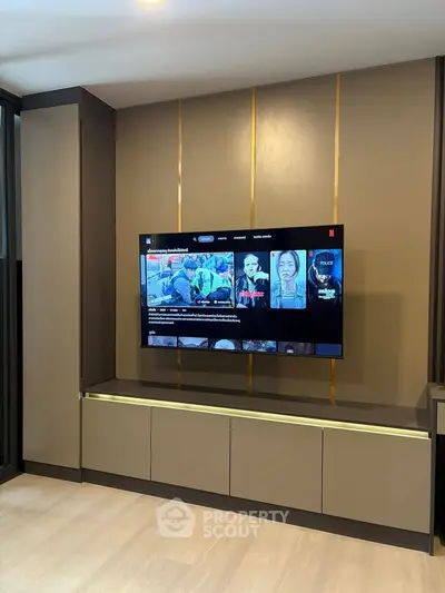 Modern living room with sleek TV unit and stylish cabinetry, perfect for entertainment and relaxation.