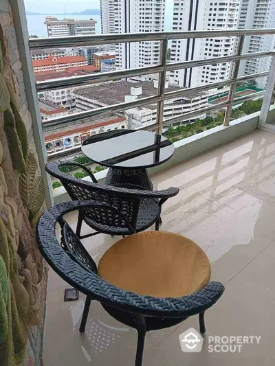 Stunning high-rise balcony with city view and modern outdoor seating