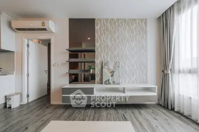 Modern living room with stylish shelving and elegant wallpaper accent wall.