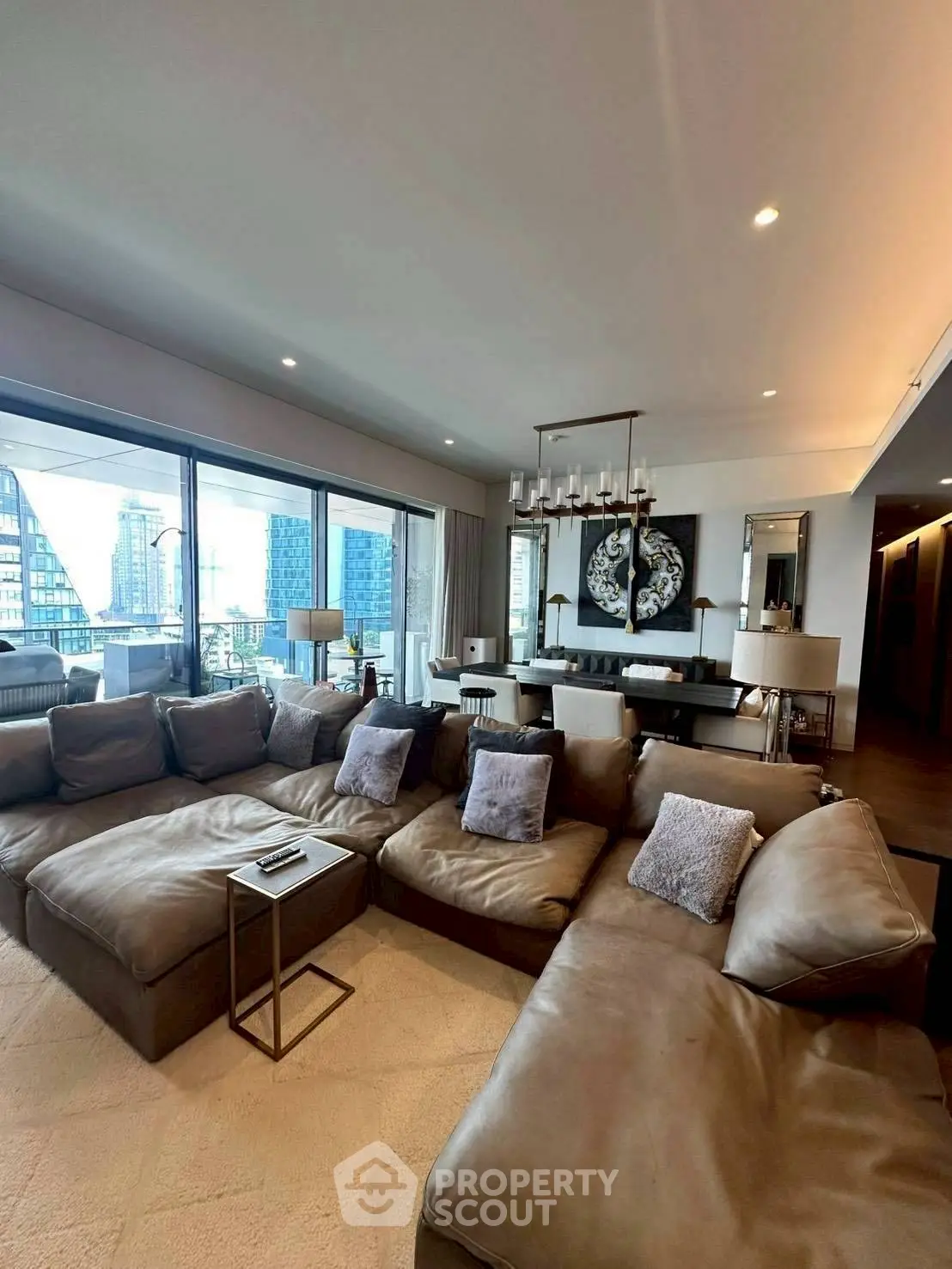 Luxurious living room with large sectional sofa and city view, perfect for modern urban living.