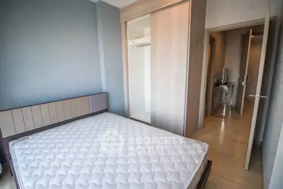 Modern bedroom with minimalist design and built-in wardrobe in a stylish apartment.