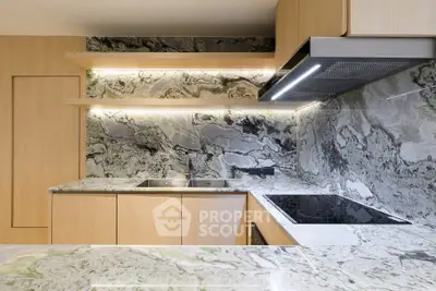Modern kitchen with sleek marble countertops and integrated appliances