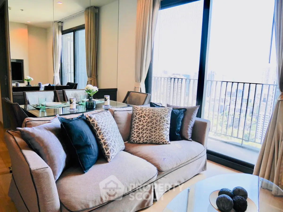 Luxurious living room with elegant decor and stunning city view from the balcony.