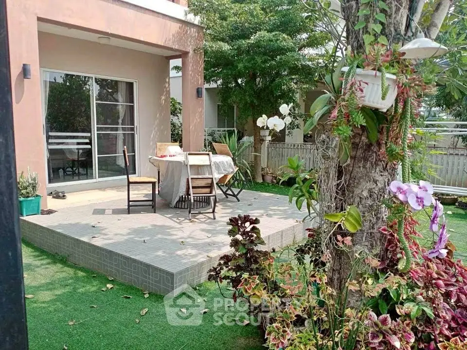 Charming garden patio with lush greenery and outdoor dining area